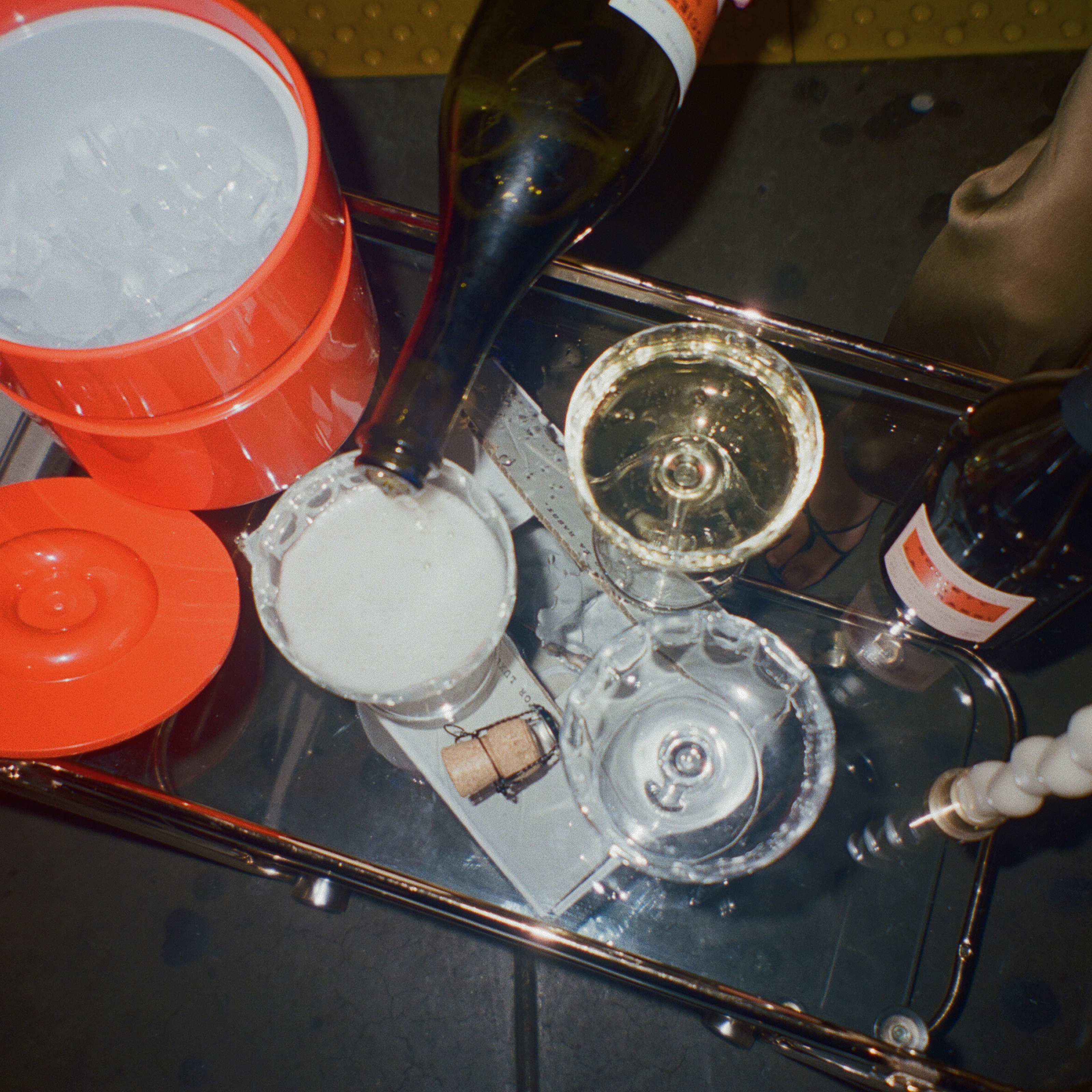 bar cart with three glasses being filled up with NA sparkling wine