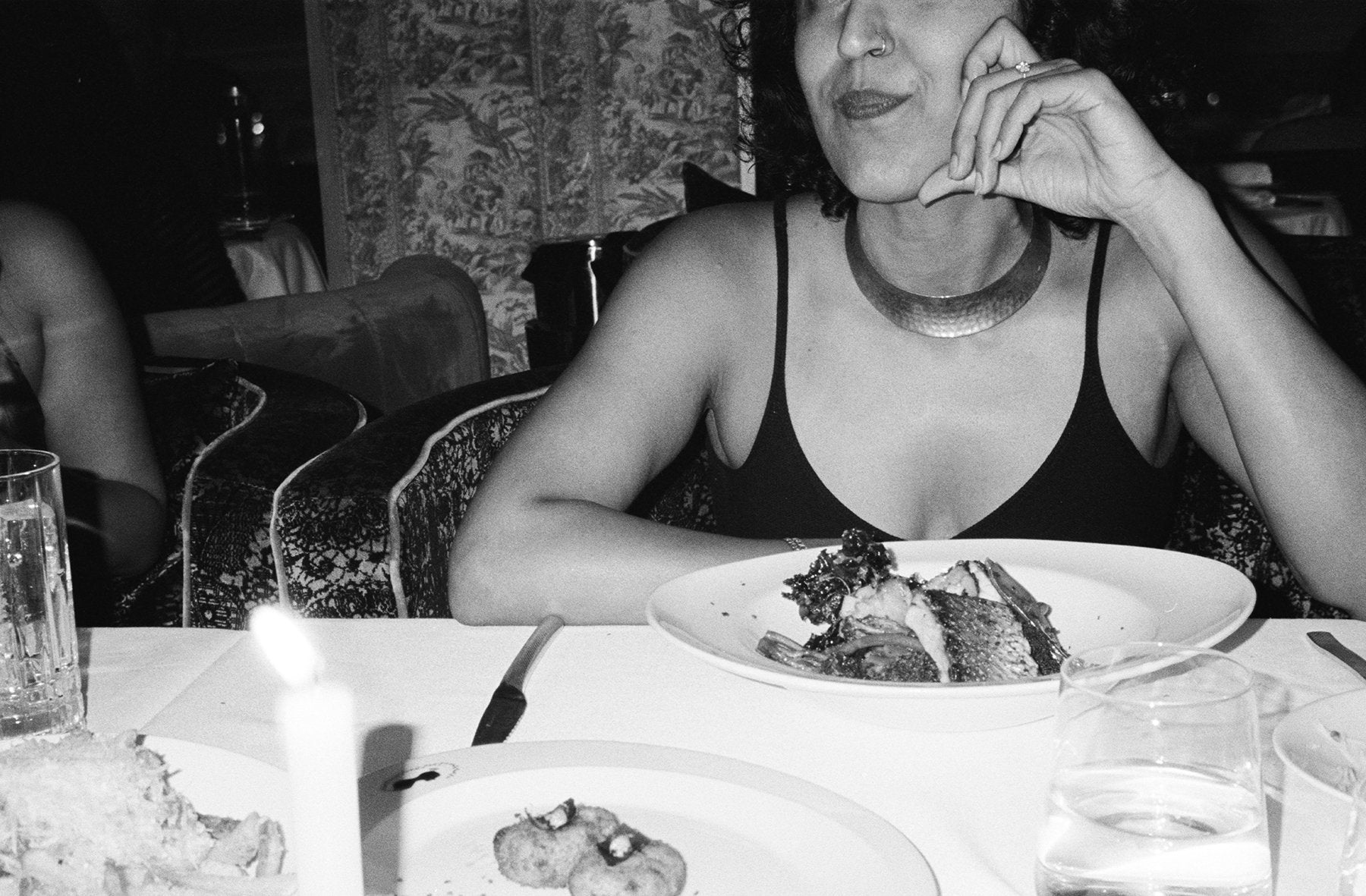 close up black and white shot of girl at dinner table