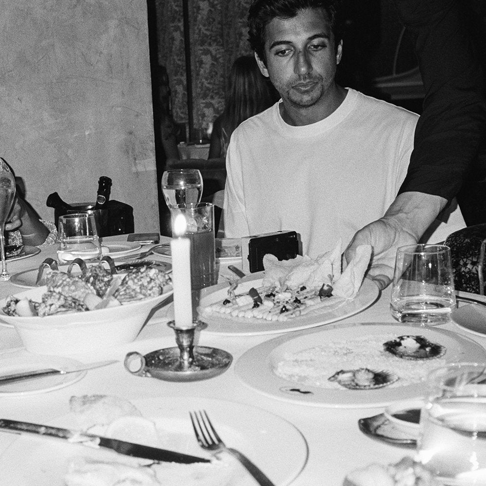guy in white tee getting served dinner at SDLR event