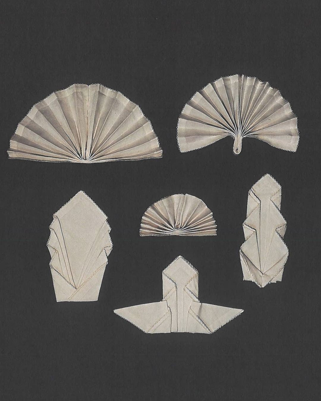 Set of folded paper shapes on a black background