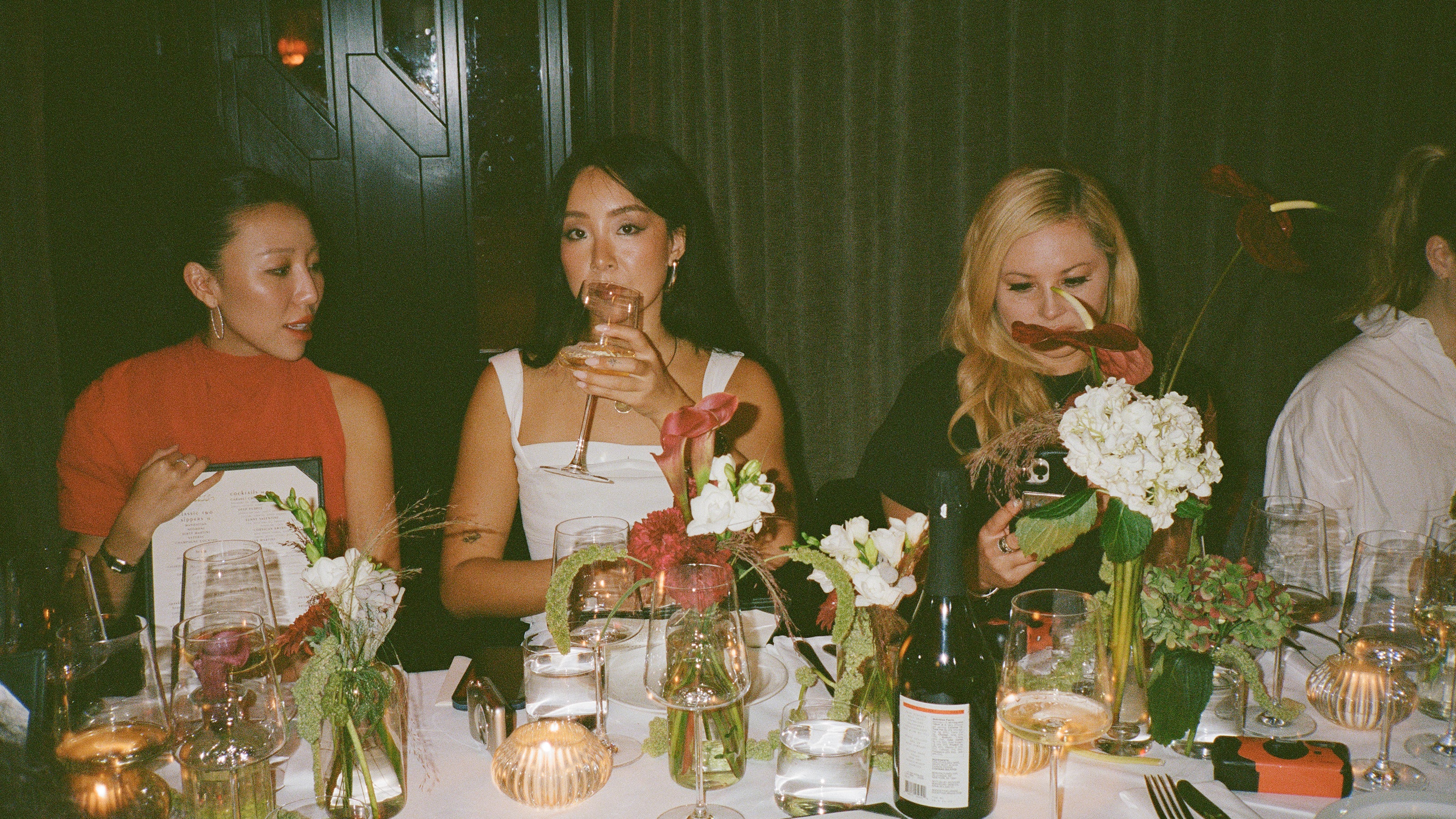 3 girls at restaurant table drinking non alcoholic wine