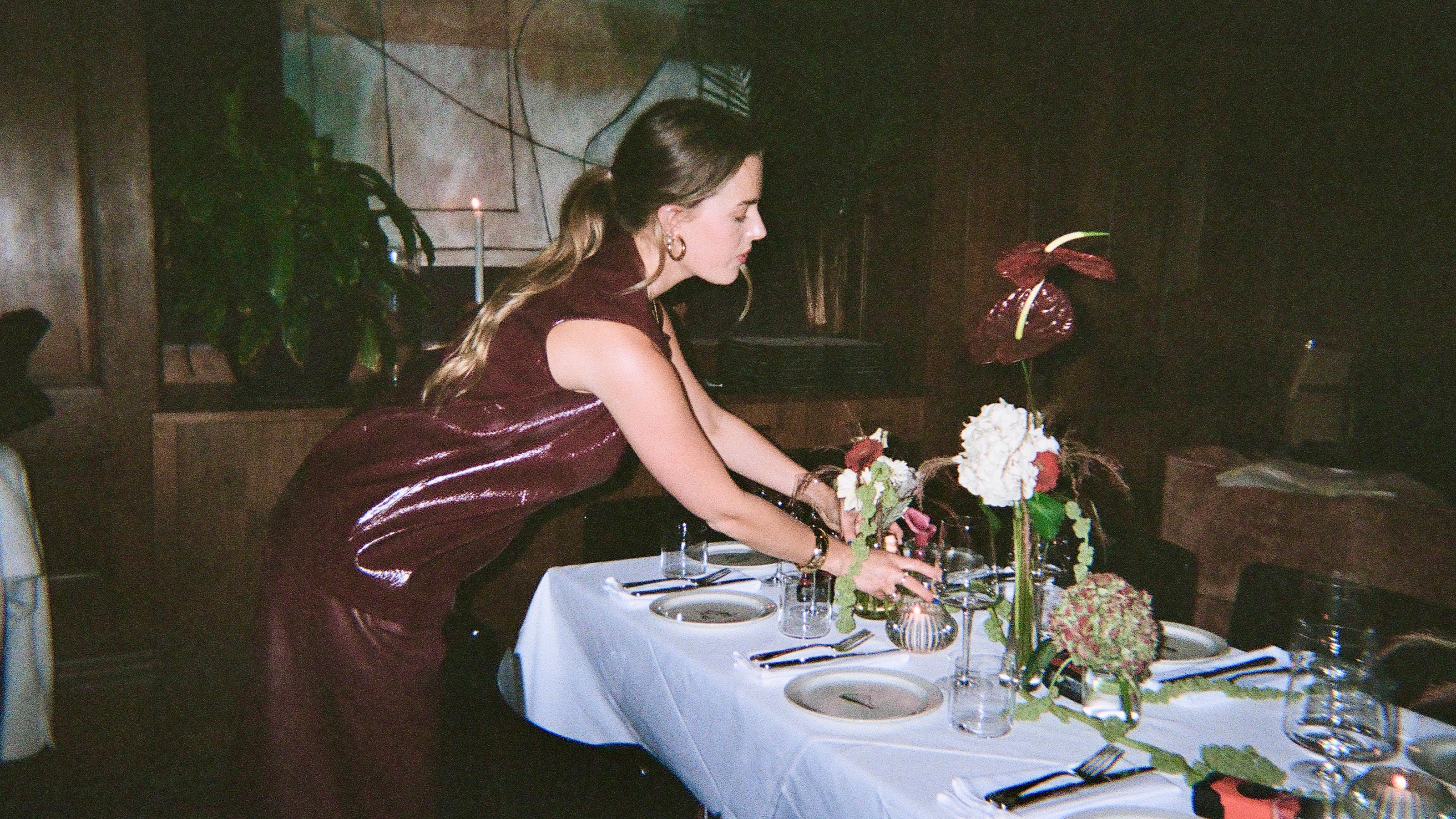 girl setting the table for SDLR event at Brass NYC