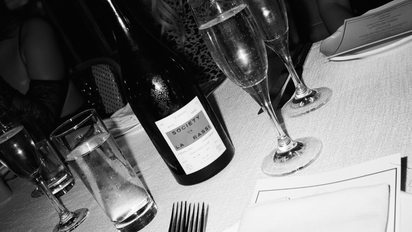 Wine bottles and glasses on a table with cutlery