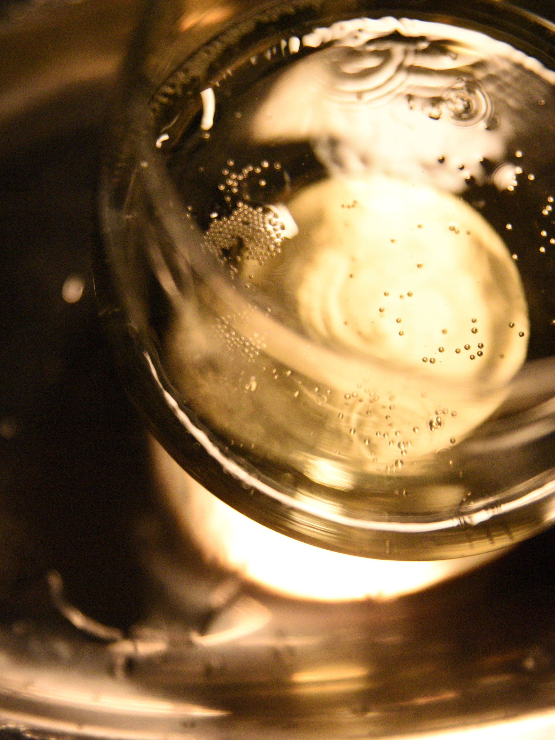 Close-up of a glass with a golden liquid and bubbles